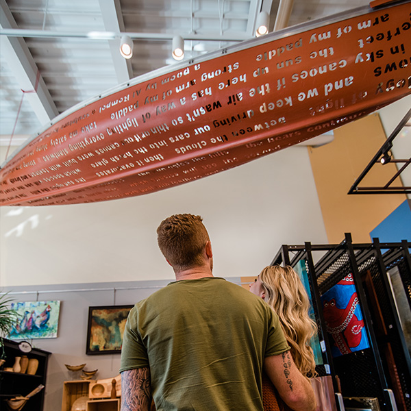 The Sky Canoe, a canoe with reflective words by Phil Morrison hangs on the ceiling of the gift shop.